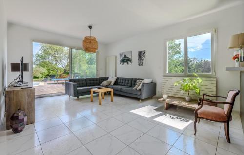 a living room with a couch and a table at 3 Bedroom Gorgeous Home In Garrigues in Garrigues