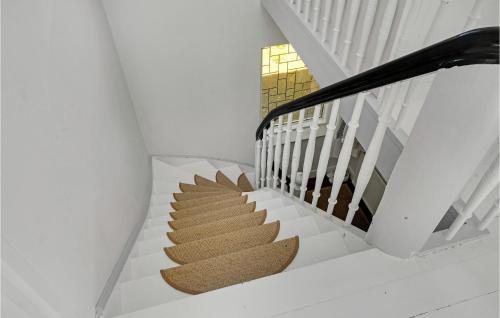 a staircase in a house with white walls at 3 Bedroom Awesome Home In Fejø in Vesterby