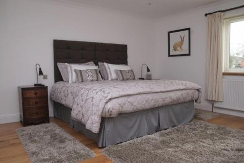 a bedroom with a large bed and a window at Cherry Tree Guesthouse in Bradford on Avon