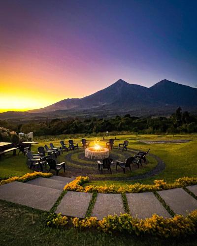 a group of benches in a park with mountains in the background at Finca San Cayetano in San Juan Alotenango