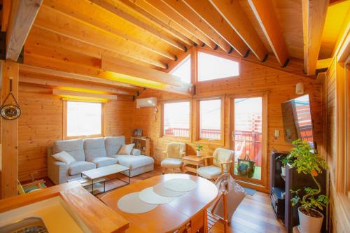 a living room with a couch and a table at 「KIRAKU」Wood House稚内 in Wakkanai