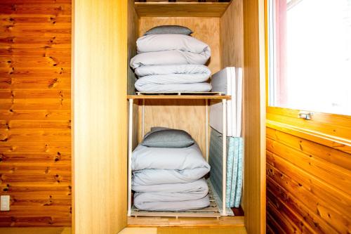 a bunch of folded towels in a closet at 「KIRAKU」Wood House稚内 in Wakkanai