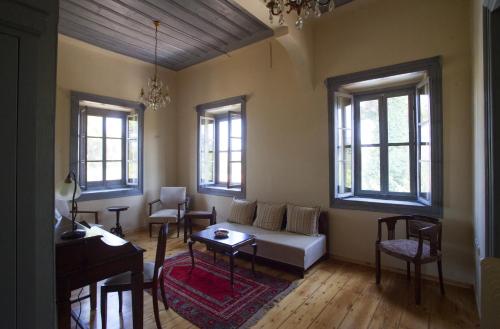 a living room with a couch and a table at Chalantra Residence in Skala Eresou