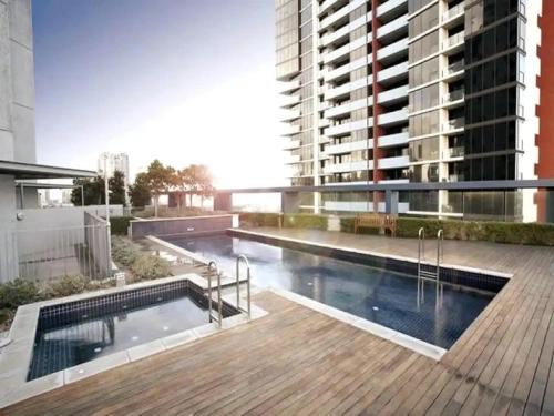 a swimming pool on the roof of a building at VAQUAY Scandi Boho In Docklands in Melbourne