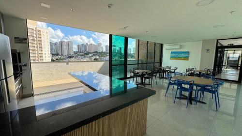 a restaurant with tables and chairs and a view of a city at Monte Carmel in Ribeirão Preto