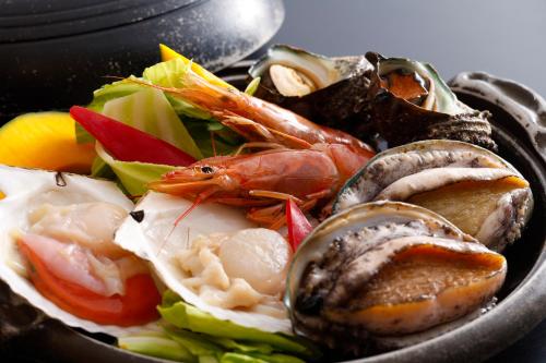 a bowl of food with seafood and vegetables at シーサイド佐竹 in Kyotango