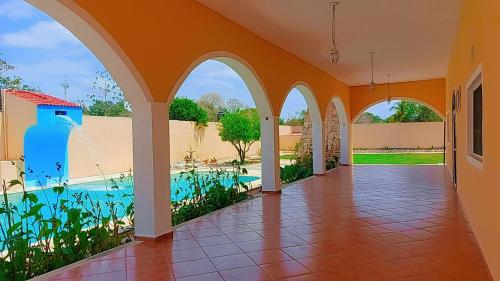 an empty hallway of a house with a swimming pool at Quinta Eva and Ivan in Kanasín