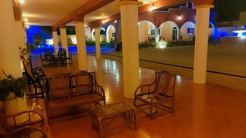 a room with chairs and tables in a building at Quinta Eva and Ivan in Kanasín