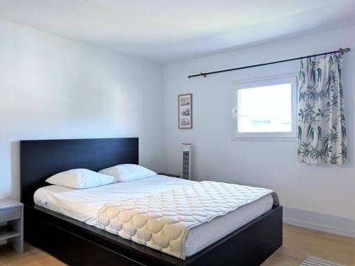 une chambre avec un grand lit avec une fenêtre dans l'établissement Appartement Duplex 100m Plage, Terrasse, Parking, 4 Couchages - Le Lavandou - FR-1-251-533, au Lavandou