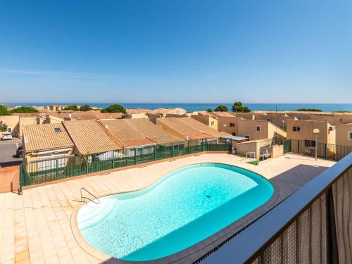 - un balcon avec vue sur la piscine dans l'établissement Charmant 2 Pièces avec Piscine, Parking Privé à 10 min de la Plage - Saint Pierre La Mer - FR-1-229D-132, à Fleury