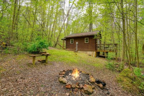 a log cabin with a fire in front of it at Blue Rose Cabins - Sweet Dreams Cabin in Logan