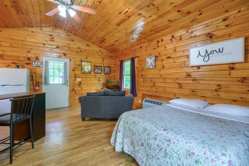 a bedroom with a bed in a wooden cabin at Blue Rose Cabins - Treetops Cabin in Logan