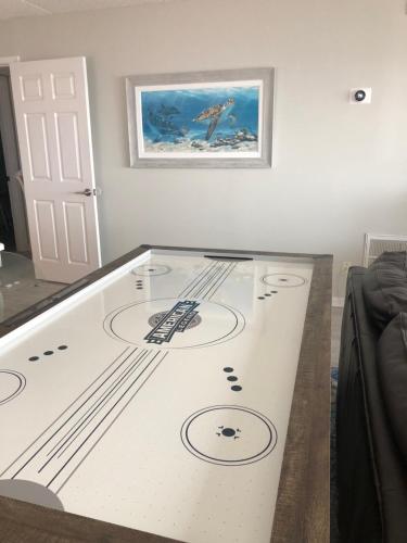 a room with a table with a hockey game on it at The Pelican in Fernandina Beach