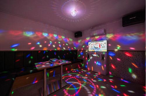 a room with a video game room with colorful lights at Brown Dot Hotel Andong Ok-dong in Andong