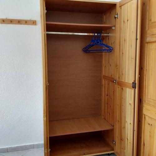 a wooden closet with wooden shelves at ANNA MARIA Studios in Potos