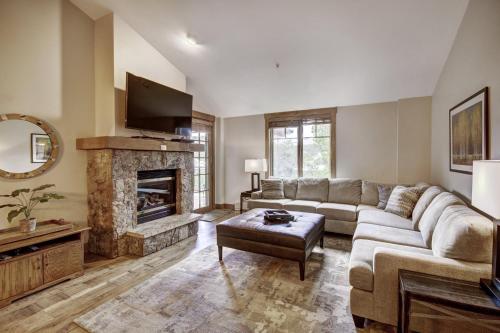 a living room with a couch and a fireplace at Mountain Thunder Lodge in Breckenridge