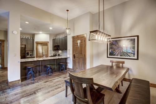 a kitchen and dining room with a wooden table and chairs at Mountain Thunder Lodge in Breckenridge