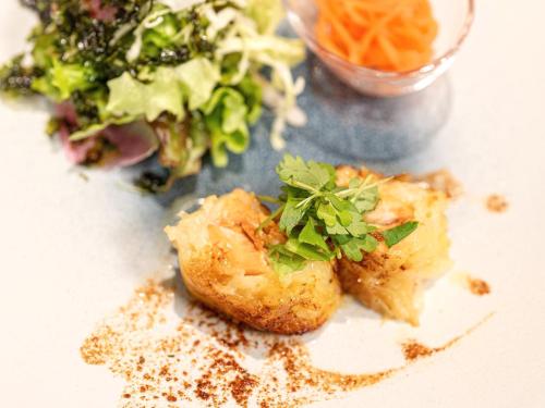 a plate of food with a salad and vegetables at Nozawa Onsen Azegamikan in Nozawa Onsen
