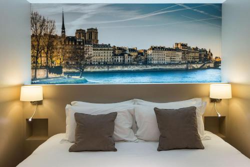 a bedroom with a large picture of a city at Midnight Hotel Paris in Paris