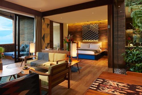 a hotel room with a bed and a couch at Potato Head Suites & Studios in Seminyak
