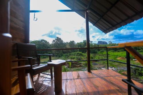a deck with a bench and a view of a mountain at Lion Wood Treehouse in Talkote