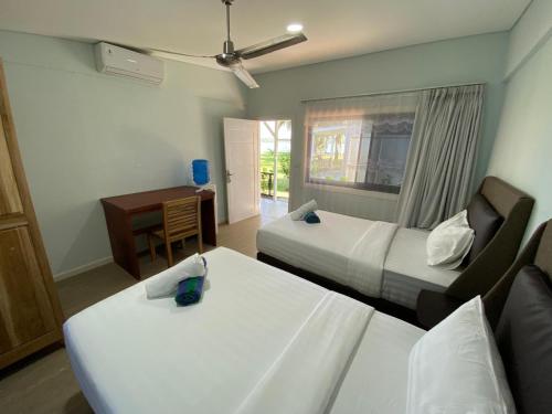 Postel nebo postele na pokoji v ubytování Nasara Resort Mentawai