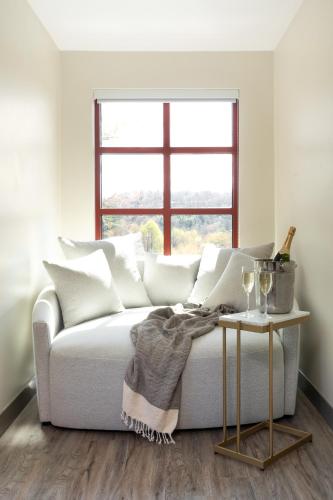 a living room with a white couch and a table at The Embers Hotel in Blowing Rock