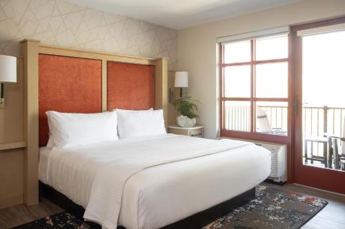 a bedroom with a large bed and a large window at The Embers Hotel in Blowing Rock