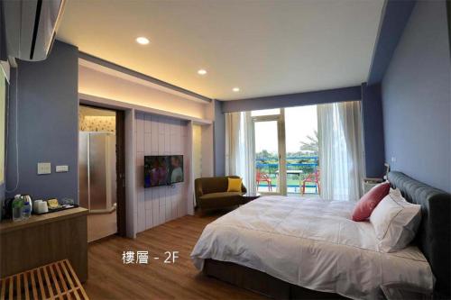 a bedroom with a large bed and a large window at The Riverview Retreats in Wujie