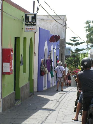 a group of people walking down a narrow street at Villa Mareblu Luxury Holiday Apartment direttamente sul mare in Stromboli