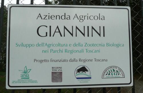 a sign for aphaia agricola clamimum on a fence at PODERE OSLAVIA AZ.AGR.BIO GIANNINI in Alberese