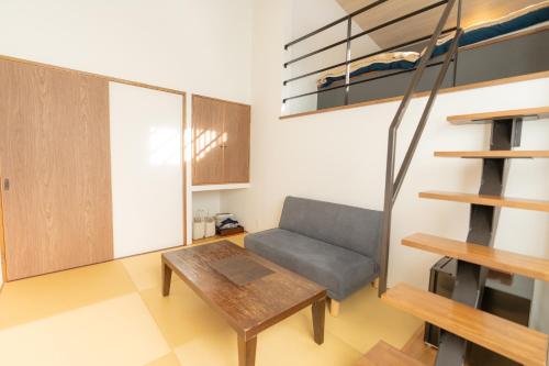 a living room with a couch and a table at Nozawa Onsen Azegamikan in Nozawa Onsen