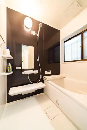 a bathroom with a shower and a tub and a sink at 58, Higashi-Horikiri 2, private house rental, 東堀切2 in Tokyo