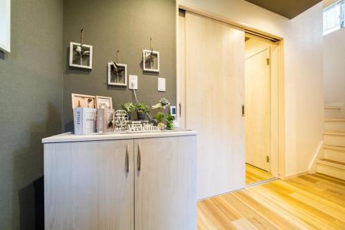 a hallway with a white cabinet and a door at 58, Higashi-Horikiri 2, private house rental, 東堀切2 in Tokyo
