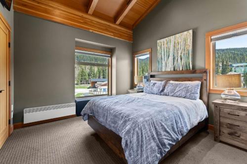 a bedroom with a bed and a window at Kookaburra Lodge #401 By Bear Country in Sun Peaks