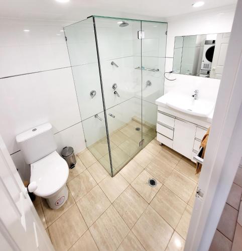 a bathroom with a shower and a toilet and a sink at 19th Avenue on the Beach in Gold Coast