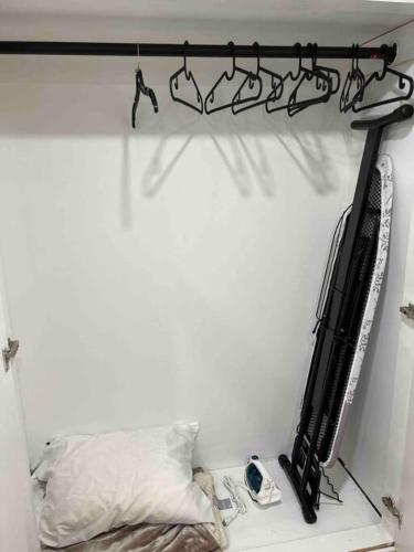 a room with a bed and a shelf with a tv at Newly renovated, laundry, separate entrance in Richmond Hill