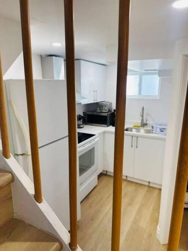 a kitchen with white cabinets and a stove top oven at Newly renovated, laundry, separate entrance in Richmond Hill