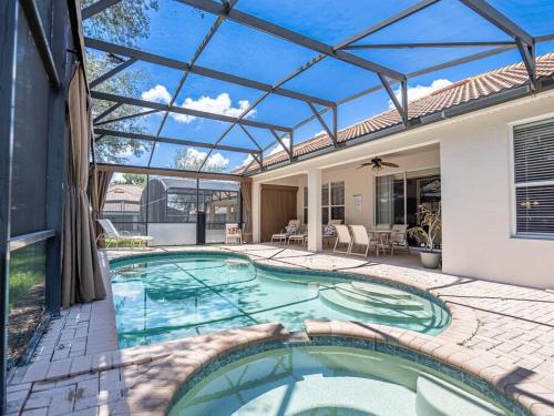 a swimming pool in a house with a glass roof at Luxury Disney Villa 5BR With Private Pool and Spa (4 Miles from Disney) in Orlando