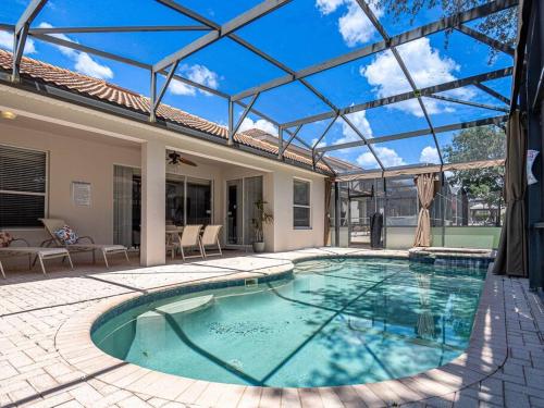 a swimming pool in a house with a glass ceiling at Luxury Disney Villa 5BR With Private Pool and Spa (4 Miles from Disney) in Orlando
