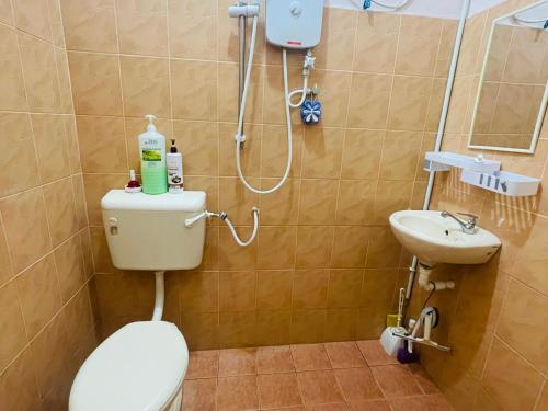 y baño con aseo y lavamanos. en Kota Bharu Homestay, en Kota Bharu