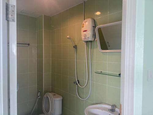 a bathroom with a shower and a toilet and a sink at Bonita House in Bangkok