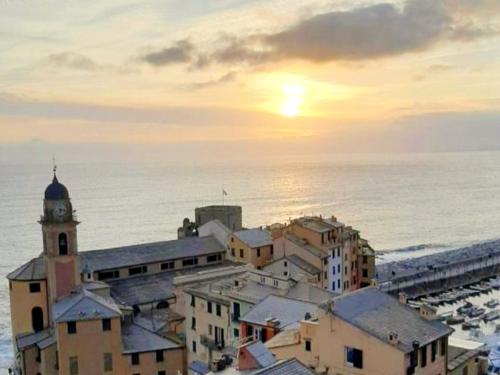 a city with a clock tower next to the ocean at Camogli vista mare in Camogli