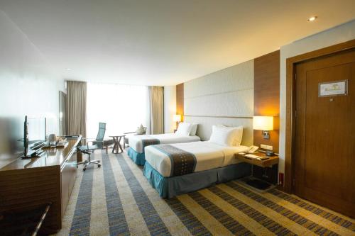 Postel nebo postele na pokoji v ubytování Lex Hotel Cebu