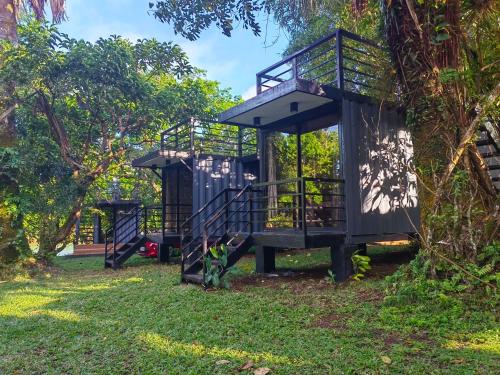 a tree house in a park with a playground at Kaliraya Surf Kamp by Eco Hotels in Cavinti