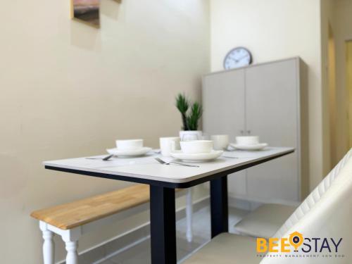 a dining room table with bowls and plates on it at Youth City Residence Family Suite KLIA AEON Mall Nilai USIM in Nilai