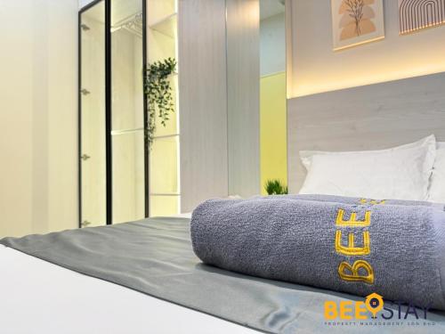 a bed with a pillow on top of it at Youth City Residence Family Suite KLIA AEON Mall Nilai USIM in Nilai