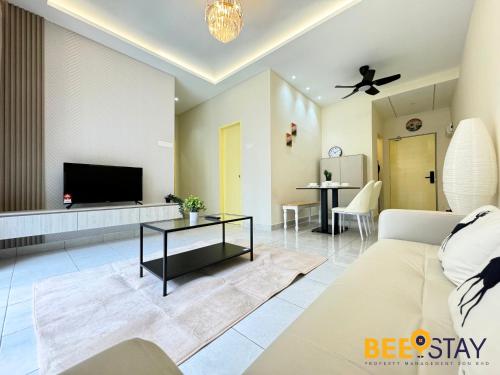 a living room with a couch and a tv at Youth City Residence Family Suite KLIA AEON Mall Nilai USIM in Nilai