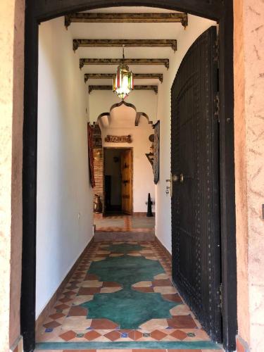 an empty hallway with a door and a rug at Dar Soulaimane in Marrakech