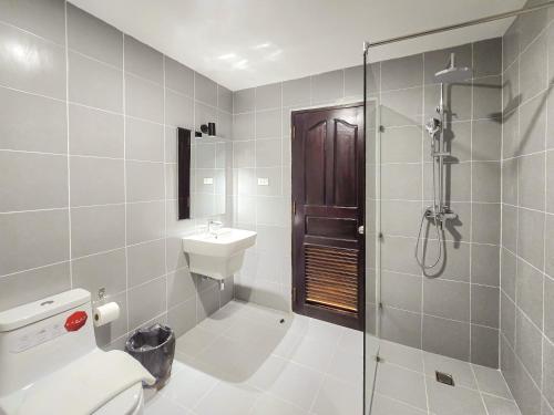 a bathroom with a shower and a toilet and a sink at Douangchan Plaza Hotel in Vientiane